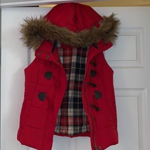 Red puffer vest with faux fur trim hood